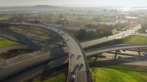 4K drone flying above multi level highway interchange on sunny evening USA Stock-Footage 168941432
