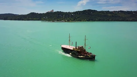 4K Drone flying above nostalgia boat on Lake Balaton towards Tihany Abbey Stock Footage 90953276
