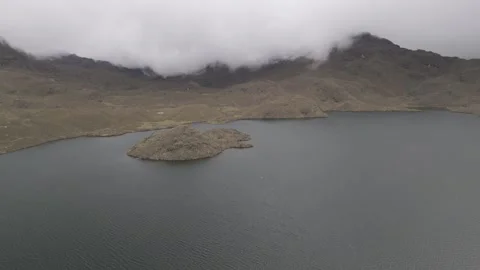 4K Drone Flying Backwards over Lake with Clouds and Mountains in the Distance Stock Footage 277211114
