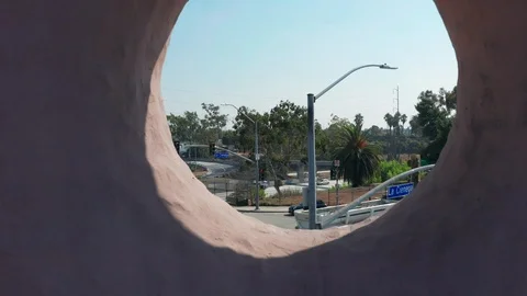 4K drone flying backwards through famous Los Angeles spot Randy's Donuts sign Stock Footage 97563327