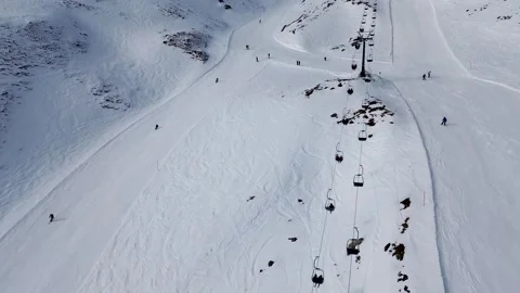4K Drone Flying Between Ski Trails with Skiers and Chairlift in Bad Gastein Stock Footage 312687701