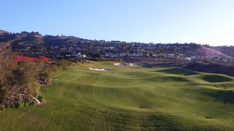 4K drone flying down fairway on Hole 1 at Trump National LA sunrise Stock Footage 89643457