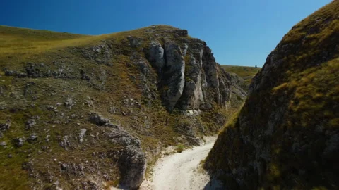 4K drone flying forward through white canyon with people walking inside Stock Footage 315191572