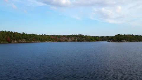 4K Drone Flying Low Over The Crystal Clear Water Of McCrae Lake, Canada Stock Footage 256704629