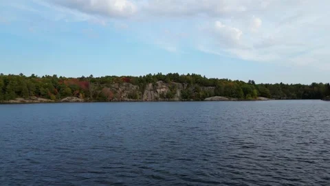4K Drone Flying Low Over The Crystal Clear Water Of McCrae Lake, Canada Stock Footage 256704650