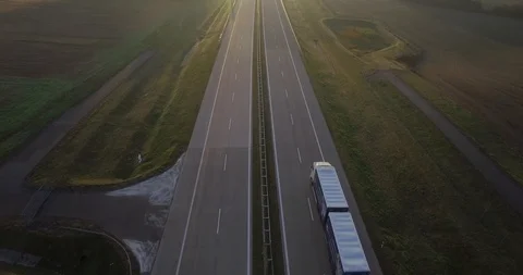 4k drone flying over dual carriageway with central reservation cars moving  Stock Footage 93374554