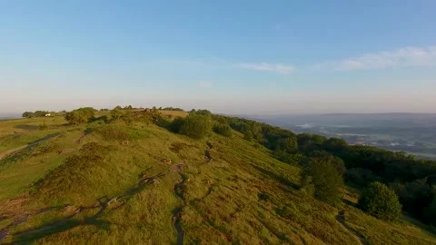 4K Drone Flying Over Grassy Hill At Sunrise In Leeds, West Yorkshire Stock Footage