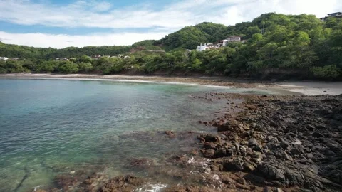 4K Drone flying over Rocks at a Private Oceanside Beach, Costa Rica Stock Footage 256828076