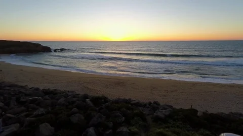 4k Drone flying over sand beach pacific ocean waves toward sunset Stock Footage 73241673