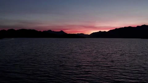 A 4k drone flying slowly over a beautiful lake at sunset, almost at night Stock Footage 249005643