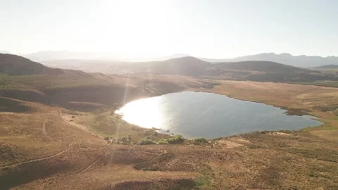 4k drone flying slowly towards a beautiful lagoon at sunset Stock Footage 249004758