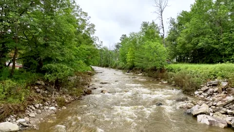 4K Drone Flying Slowly Upstream Swollen Small River in Vermont 動画素材 246536235