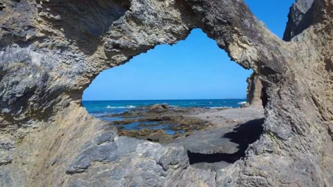 4K Drone Flying Through Rock Hole to Coastal Ocean Stock Footage 331623189