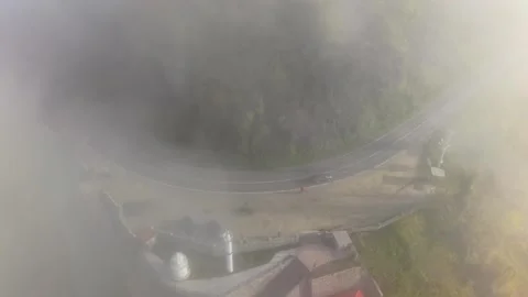 4K Drone Flying Toward a Lighthouse and Foggy Coastal Road Video stock 339237424