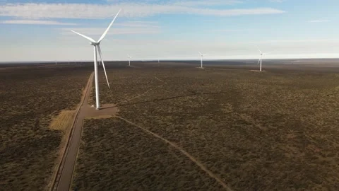 4K Drone flying towards a wind turbine generator in the desert. Clean power. Stock Footage 154615454