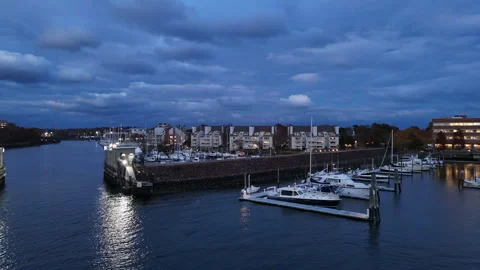 4k drone following man on small boat with dog docking at dusk Stock Footage 291285380