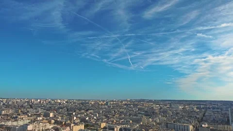4K drone footage of blue sky over Paris city center with lots of plane traces Stock Footage 282916088