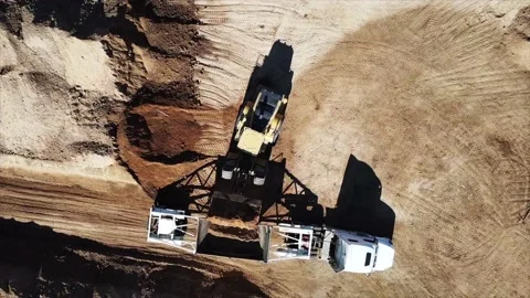 4k drone footage of a bulldozer filling a dump truck Stock Footage