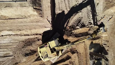 4k drone footage of a construction digger moving dirt Stock Footage 146465154