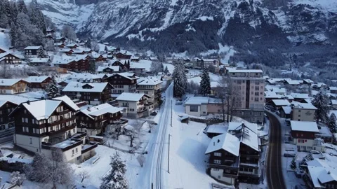 4K Drone Footage: Grindelwald Train Station Amidst Winter Scenery, Switzerland Stock Footage 246608948