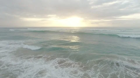 4k Drone footage of ocean waves reaching shore. Footage is filmed from an overhe 動画素材 199618461
