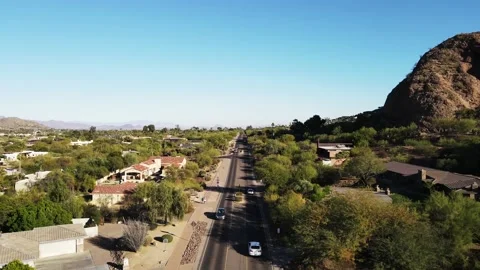 4k drone footage of road, homes and mountains in paradise valley, az Stock Footage