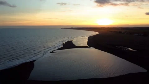 4k drone footage of the sun setting over the coast at Shingle Street in Suffolk Video stock 168238233