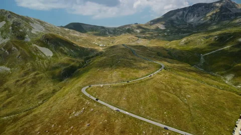 4K drone forward close to winding road in green-yellow mountain valley Stock Footage 315209644