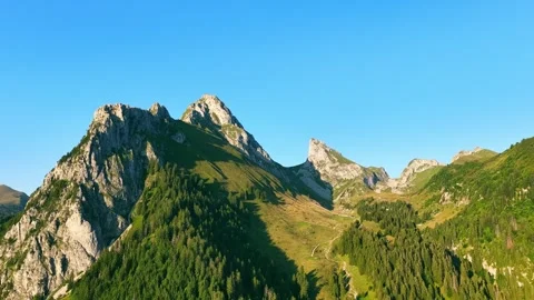 4K drone forward over alpine ridge and forest trail Stock Footage 331063409