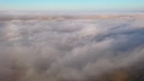 4K Drone Gliding Above Sea Fog at Golden Sunset Stock Footage 339315840