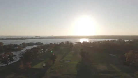 4k drone golf course on coastline of harbor, camera moves forward toward horizon Stock Footage 290938607
