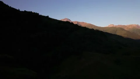 4K Drone The helicopter rises, revealing a view of the hills and mountain ranges Stock Footage
