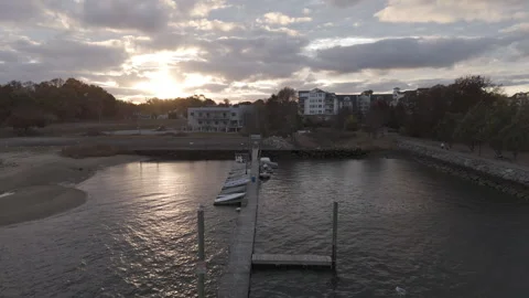 4k drone moving forward down small dock with boats lined on top Stock Footage 291222709
