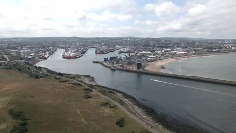 4K Drone Orbit of Aberdeen Harbour Entrance with Boat Entering Port Stock Footage 340414451