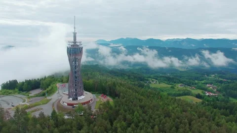 4K Drone Orbit of Pyramidenkogel Tower with Alps Mountain Range Stock Footage 336656557