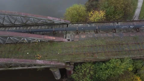 4K drone over along derelict industrial railway bridge with rusty railway track Vídeos de archivo 229648534
