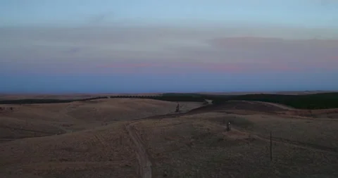 4K Drone Over Barren Spooky Kern County Farmland at Dusk Stock Footage 250687494