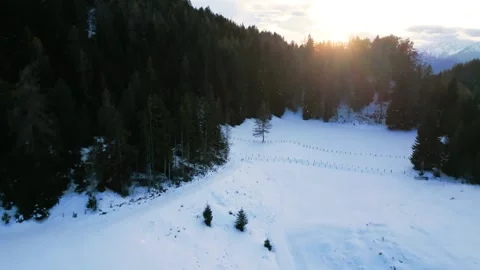 4K drone overflight over a snow-covered mountain forest at sunset Stock Footage 301542208