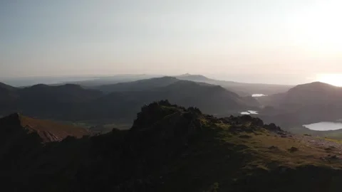 4K drone overlooking the Eryri / Snowdonia mountains and Welsh coastline Stock Footage 250471237