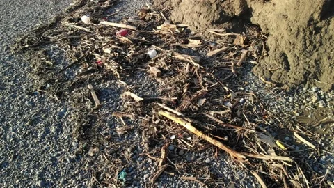 4K Drone plastic litter washed up on beach strandline, Wales 動画素材 186475035