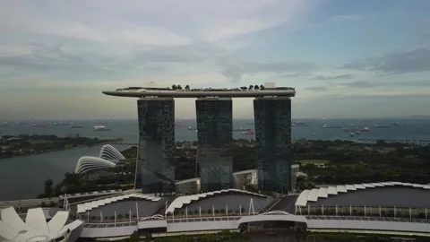 4K Drone Pull Back From Futuristic Bayfront Hotel and Ocean View Stock Footage 315138911