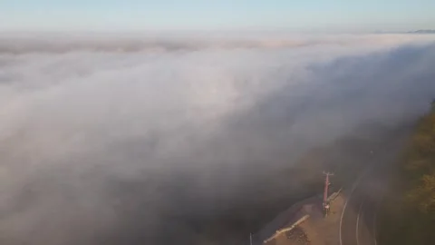 4K Drone Pullback and Ascent Above Foggy Coastal Lighthouse Video stock 339315350