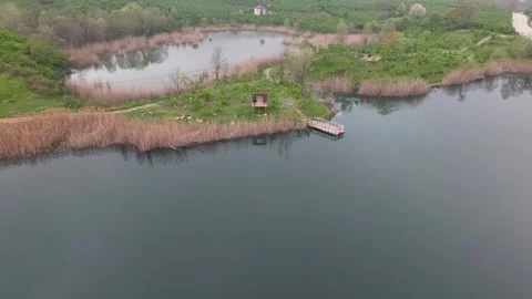 4K Drone Pullback Rising Shot Facing Wooden Pier on Gaga Lake in Cloudy Weather Video stock 335762412