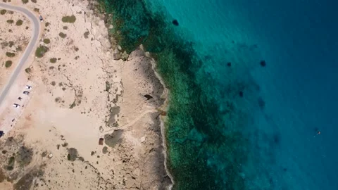 4K drone reveal shot of the sea with crystal clear water and rocks Stock Footage 236792353