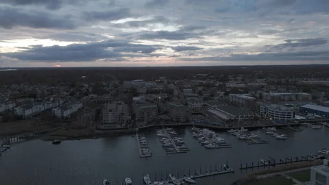 4k drone reverse from horizon with docked boats at sunset Stock Footage 291278557
