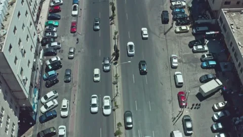 4K Drone reverse shot with gimble rotation on busy street in Amman 5/5/2023 Stock Footage 297231986