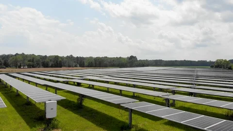 4K drone rises up over large solar panel field Stock Footage 129788968