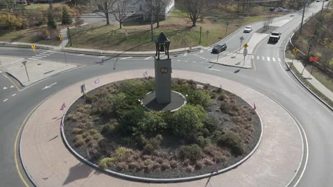 4k drone rotating around traffic circle bell tower Stock Footage 289783821