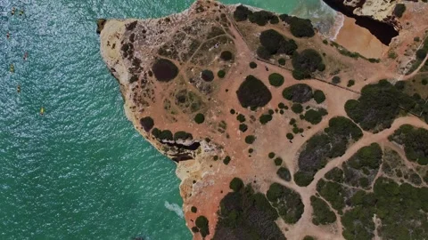 4K Drone. Rugged rocky cliffs, beach, sandy coast ocean waves. Algarve. Portugal Stock Footage 240127975
