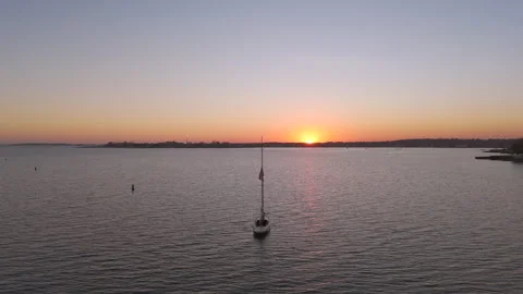 4k drone sailboat docked during sunset, camera moving right to left Stock Footage 290918545